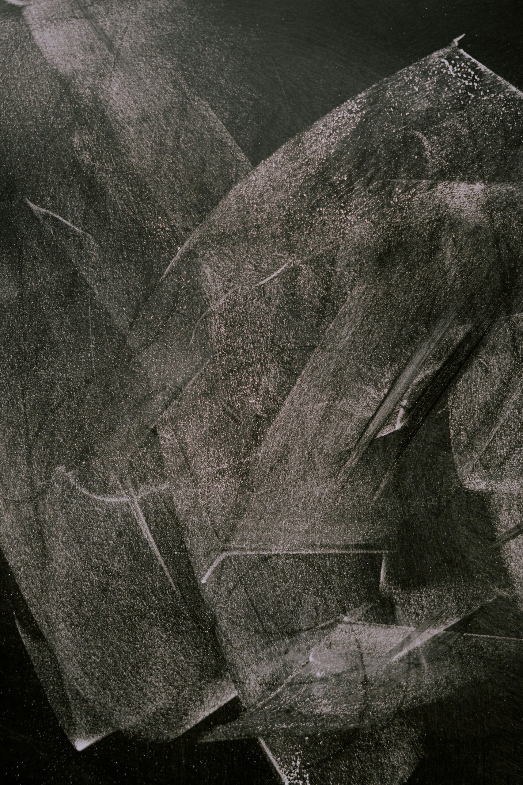 Abstract blackboard surface with smudged chalk marks, ideal for backgrounds.